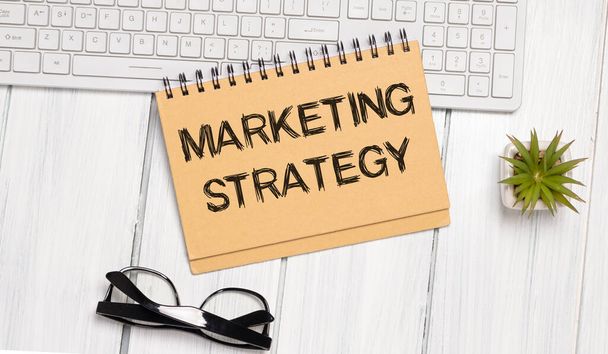 Notebook with Toolls and Notes about Marketing Strategy,concept - Foto, Imagen
