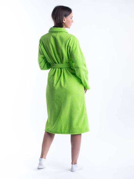 woman in a dressing gown from the back on an isolated white background. Shot in the Studio in full growth. - 写真・画像