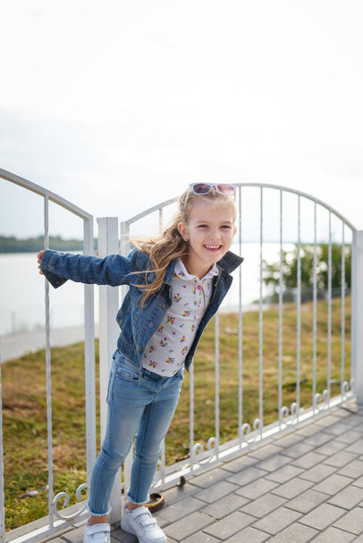 Little smiling girl outdoors portrait. Carefree chidhood - Photo, Image