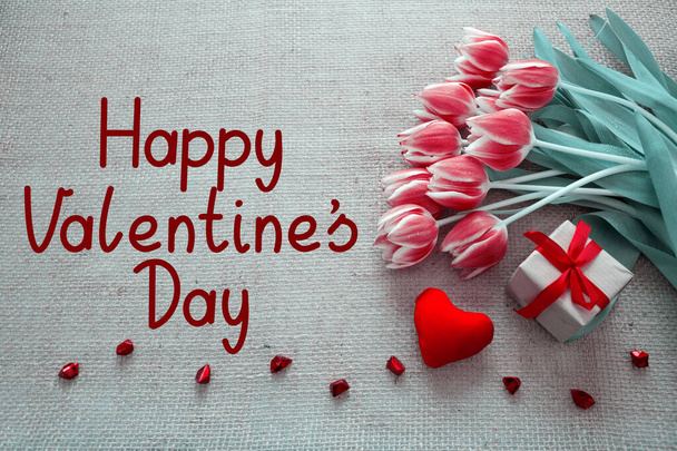 Valentijnsdag achtergrond met tulpen en rood hart op doek Achtergrond. - Foto, afbeelding