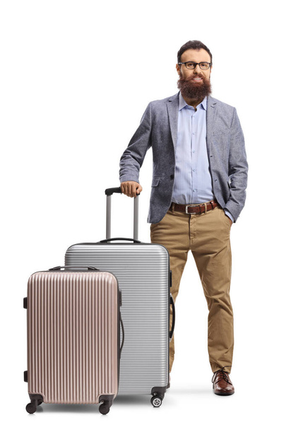 Full length portrait of a bearded man with two suitcases isolated on white background - Fotó, kép