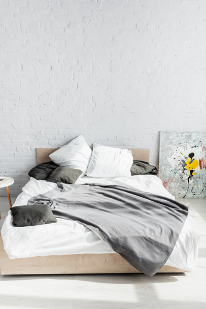 Coperta grigia e cuscini sul letto a casa  - Foto, immagini
