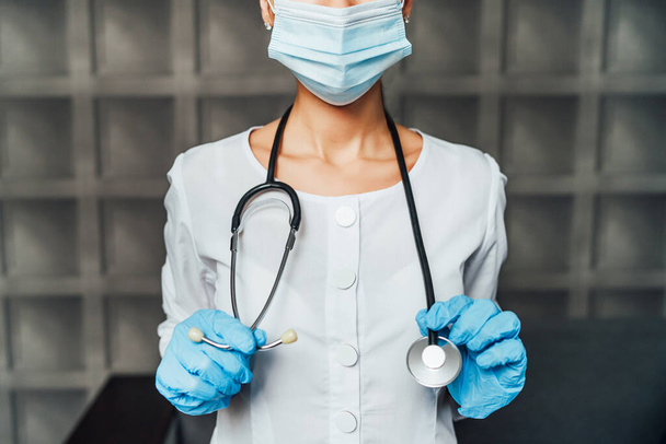 Close up of nurse in protective mask, with stethoscope and protective gloves. - Fotoğraf, Görsel