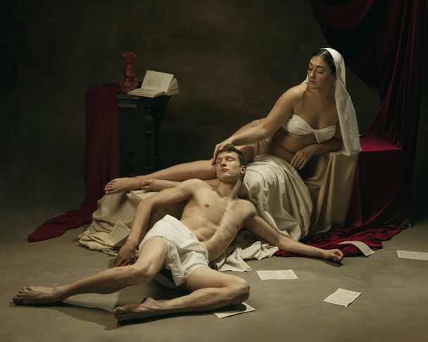 Modern remake of classical artwork - young medieval couple on dark background, comparison of eras concept - Zdjęcie, obraz