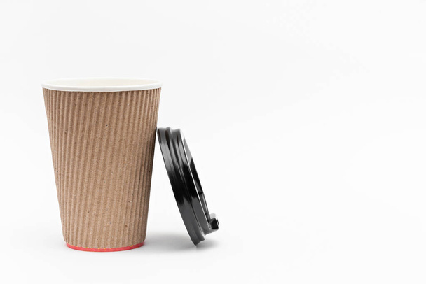 one cardboard cup for coffee and lid on a white background - Photo, Image