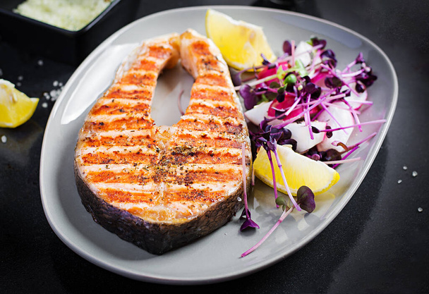 Salmon. Salmon fish steak grilled and radish salad with microgreens. Healthy food. - Fotoğraf, Görsel