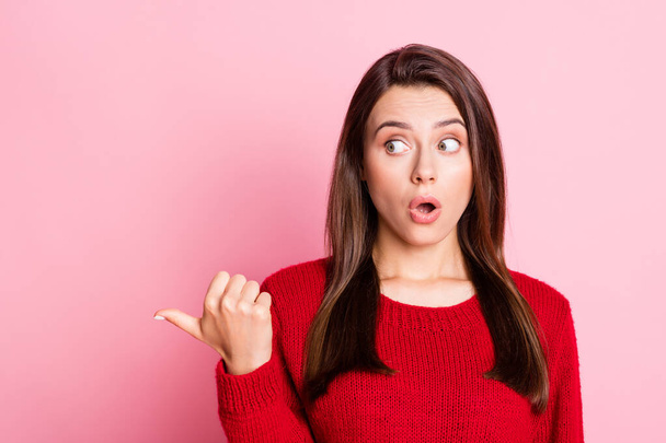 Photo of young shocked lady indicate finger funny look empty space wear red pullover isolated pink color background - Fotoğraf, Görsel