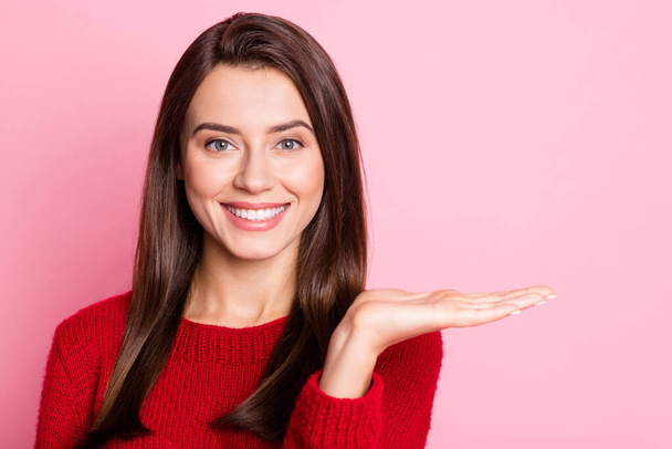 Photo portrait of pretty happy girl with brown hair smiling holding hand near shoulder showing copyspace isolated on pink color background - Foto, immagini
