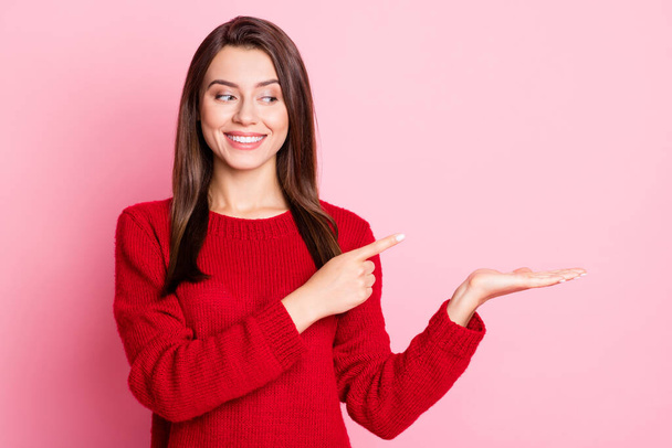 Photo portrait of curious cunning girl with brunette straight hair pointing on empty space smiling looking at side isolated on pink color background - Φωτογραφία, εικόνα