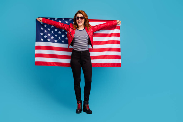 Full length body size view of nice attractive pretty cheerful cheery glad wavy-haired girl holding in hands USA flag learn English language isolated on bright vivid shine vibrant blue color background - Valokuva, kuva