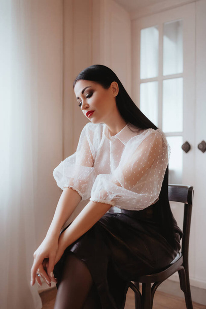 beautiful young woman in white blouse posing in studio - Fotografie, Obrázek