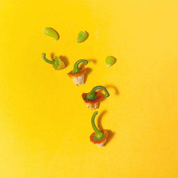 Flat lay of top paprika arrangement of different size and colors. Top view on yellow background. - Foto, Imagem