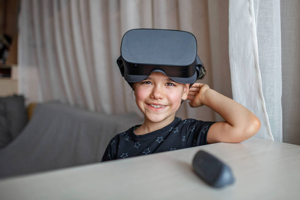 Cute girl in virtual reality googles at home, remote education experiment, future today - Fotó, kép