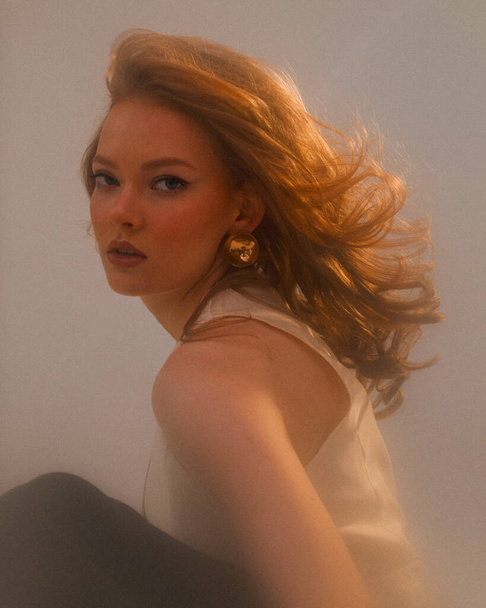 Redhead young pretty girl wearing golden earings, studio portrait of sensual ginger female - Fotografie, Obrázek
