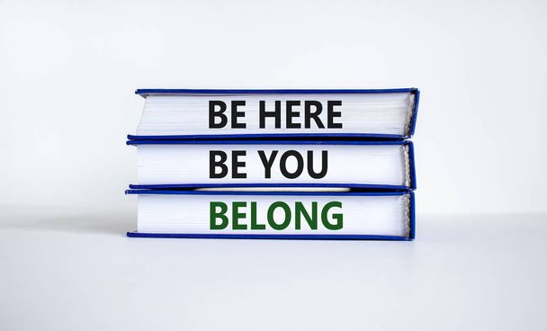 Belong symbol. Books with words 'be here, be you, belong' on beautiful white table, white background. Business, belonging and inclusion concept. Copy space. - Foto, Imagem