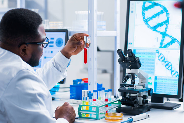 Professional African-American scientist is working on a vaccine in a modern scientific research laboratory. Genetic engineer workplace. Future technology and science. - Fotografie, Obrázek