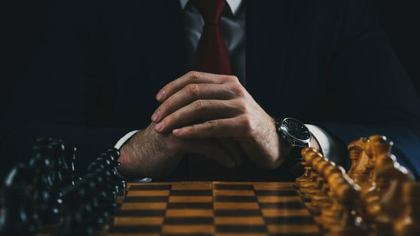 the concept of strategy and business planning, a businessman at a chessboard with figures lined up in their places, strategy and tactics, readiness for battle. - Foto, Bild