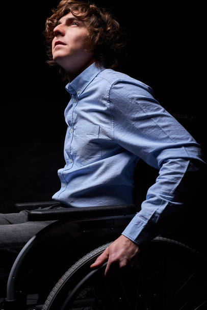 young caucasian male sitting on wheelchair - Фото, зображення
