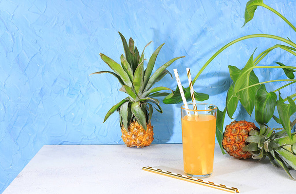 Fruit juice and ingredients, summer pineapple drink and mini pineapple on bright table with long shadows, detox diet and weight loss concept, healthy and natural food, vitamin C source, selective focus - Foto, imagen