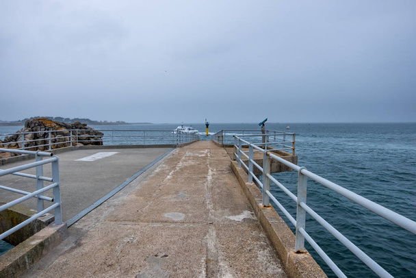Roscoff, Francia - 28 de agosto de 2019: El faro del embarcadero de pontones. Pasarela de ferry a Ile De Batz en Roscoff. Puente conduce a la terminal de ferry de aguas profundas - Foto, Imagen