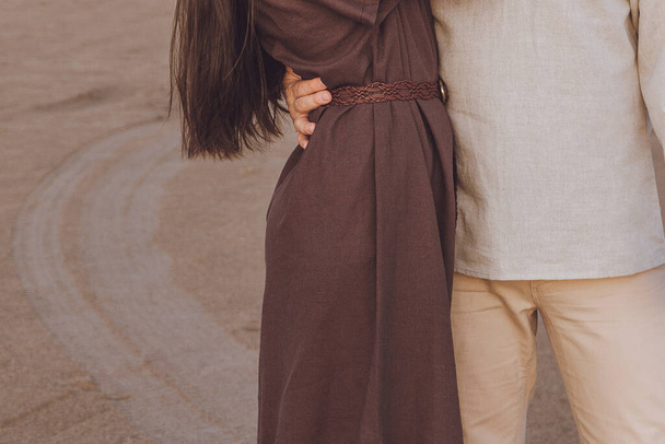 Close-up of young couple hugging outdoor. Family look linen clothes - Photo, Image