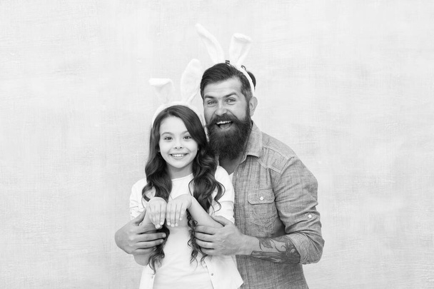 Dad and daughter bunny ears. Father and child celebrate easter. April sale concept. Spring holiday. Easter activities for family. Happy easter. Holiday bunny long ears. Family tradition concept - Foto, Bild