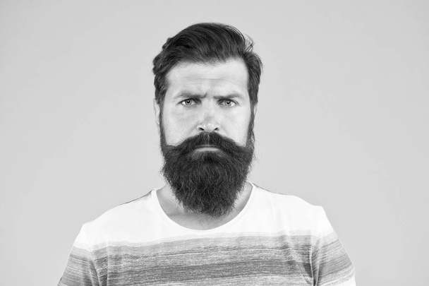 bend his brows. serious stylish man with moustache. thinking brutal bearded man on yellow background. handsome confident man has perfect hairstyle. male facial care. portrait of brutal bearded man - 写真・画像