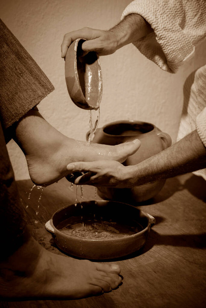 Jesus Christ washing the feet of his disciples in sign of humility and service - 写真・画像