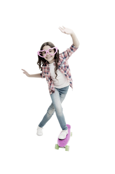 Lets have fun. Kid having fun with penny board. Child smiling face stand skateboard. Penny board cute skateboard for girls. Lets ride. Girl ride penny board white background. Summer vacation - Foto, Bild