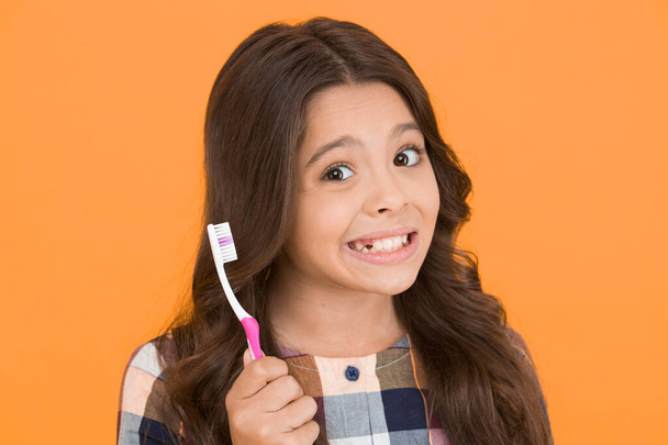First thing to do in morning. Happy child brush teeth in morning. Little girl smiling with tooth brush. Oral hygiene and morning routine. Get rid of morning breath - Fotó, kép