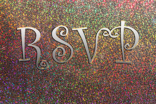 RSVP in fettem Chrom Text auf einem Regenbogenglitzern abstrakten Hintergrund. - Foto, Bild