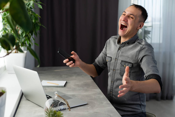 Euphoric happy businessman scream read good online news celebrating business success, great result watching game on laptop, excited by victory, betting win, professional achievement, feeling winner - Fotografie, Obrázek