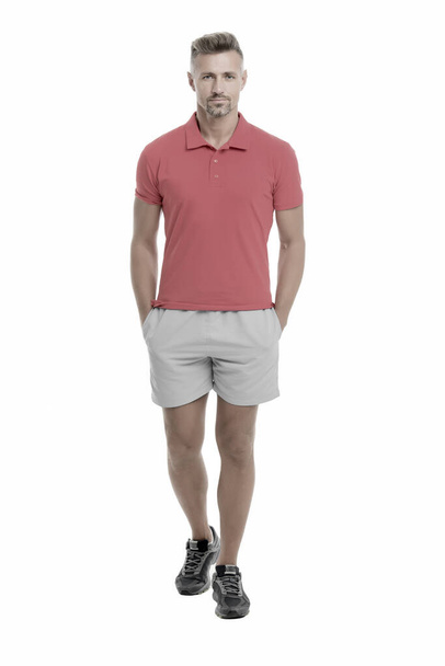Sport style. Menswear and fashionable clothing. Man calm face posing confidently white background. Man looks handsome in shirt and shorts. Guy sport outfit. Fashion concept. Man model clothes shop - Foto, afbeelding