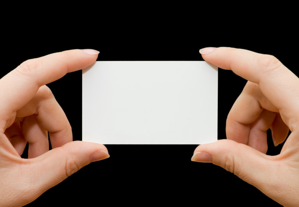Paper card in woman hand isolated on black background - Fotó, kép