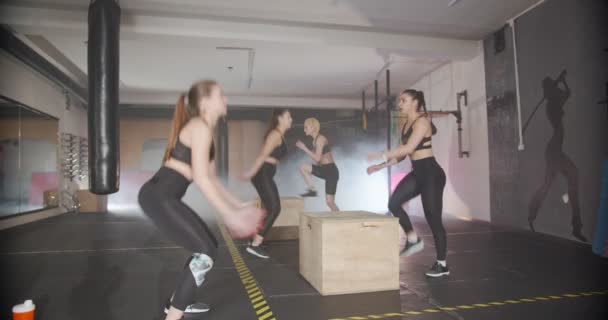 Четыре девушки одновременно делают прыжки в коробку и нормальные прыжки, замедленная съемка - Кадры, видео