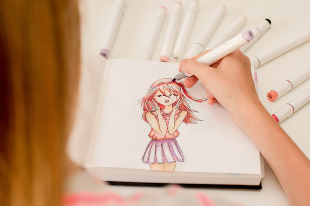 Hand drawing a cute girl anime style sketch with alcohol based sketch drawing markers. - Photo, Image