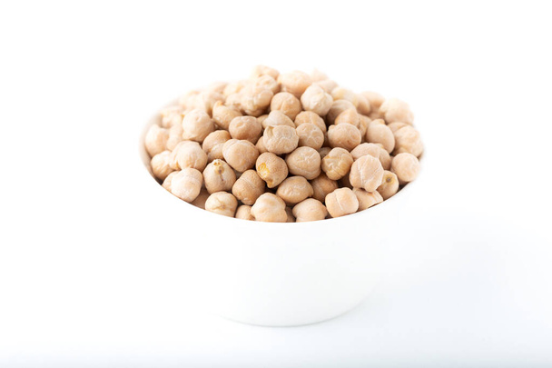 Dried chickpea beans in white bowl isolated on white background. - Photo, Image