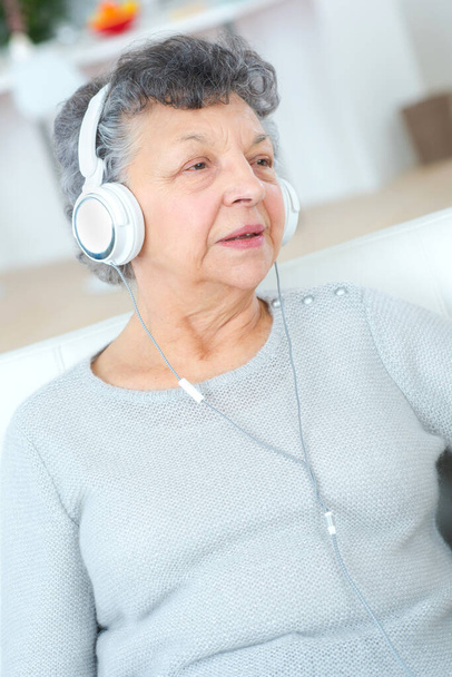 senior woman listening music with headphones - Fotoğraf, Görsel