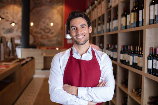 portrait of handsome sommelier in cellar - Photo, Image