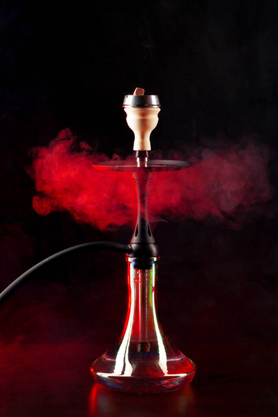 Smoking hookah on black background with color fog - Foto, immagini