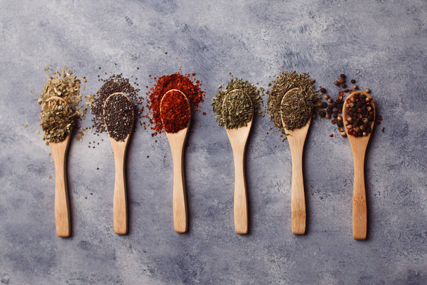 A top view of assortment of spices: chia, paprika, parsley, rosemary, and teas - Photo, Image