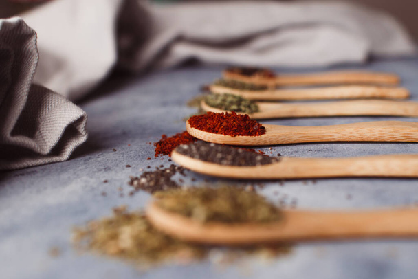 A selective focus shot of assortment of spices: chia, paprika, parsley, rosemary, and teas - Foto, immagini