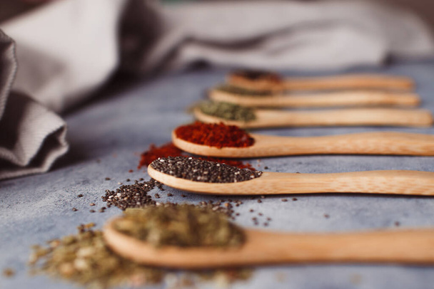 A selective focus shot of assortment of spices: chia, paprika, parsley, rosemary, and teas - Foto, Imagen