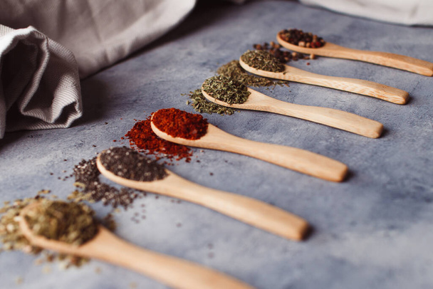 A selective focus shot of assortment of spices: chia, paprika, parsley, rosemary, and teas - Zdjęcie, obraz