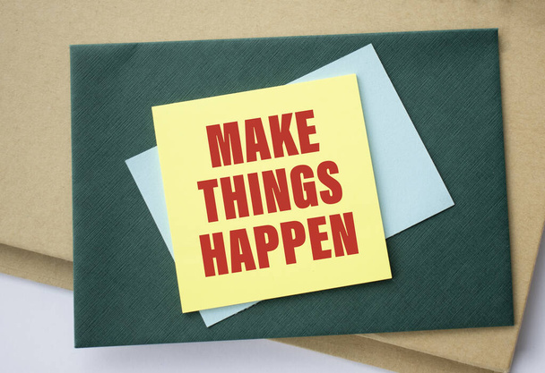 Make things happen motivational reminder - handwriting on a green sticky note - Foto, imagen