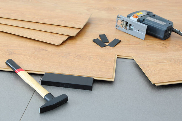 Laminate board on a gray base and fixtures for its installation  - 写真・画像