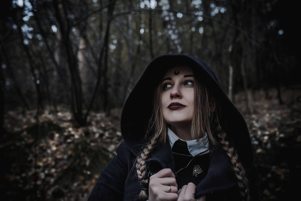 Witch in the form of a student in the forest - Фото, зображення