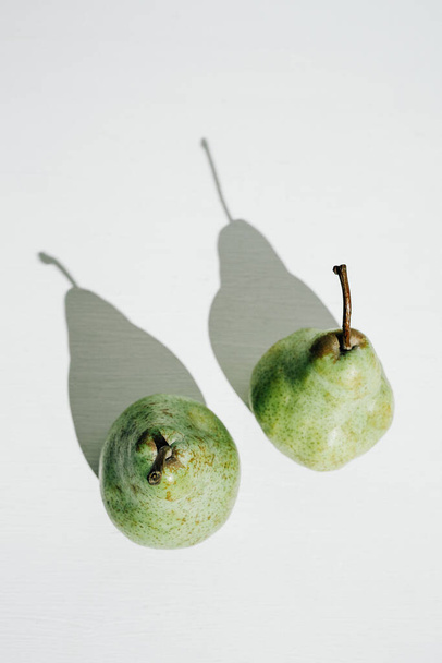 Two green pears minimalism, healthy food, vitamins and vegetarianism concept. Top view, flat lay - Foto, immagini