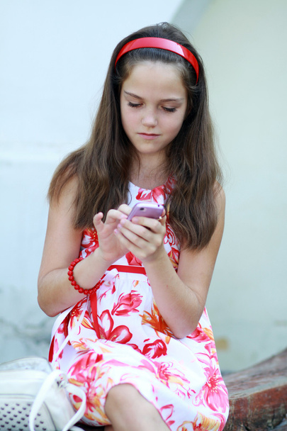 Little girl talks by mobile phone - Zdjęcie, obraz