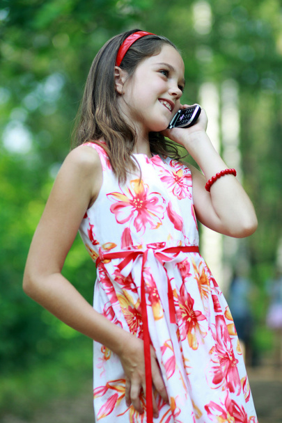 Little girl talks by mobile phone - Фото, изображение